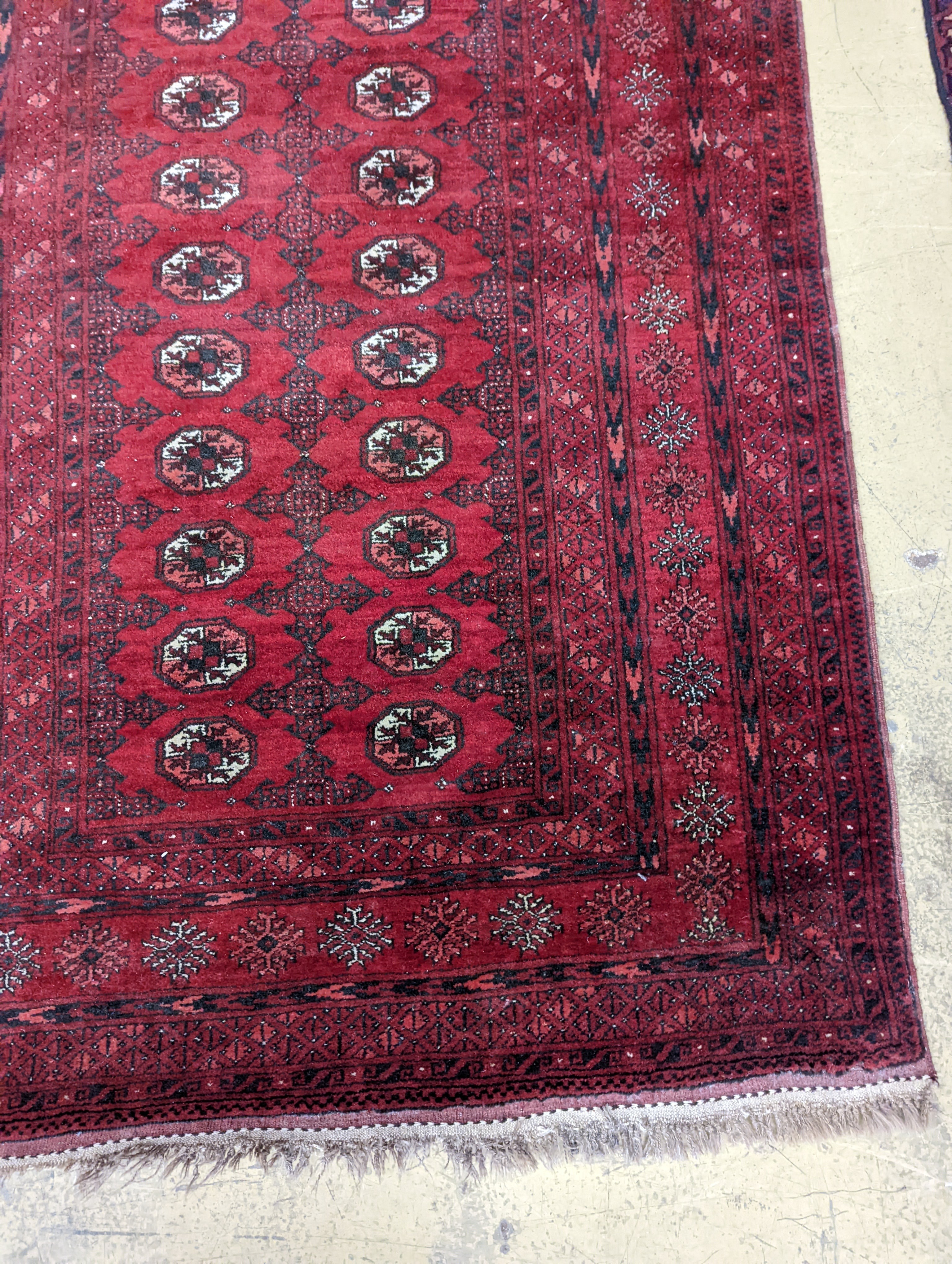 A Bokhara burgundy ground rug, 190 x 130cm